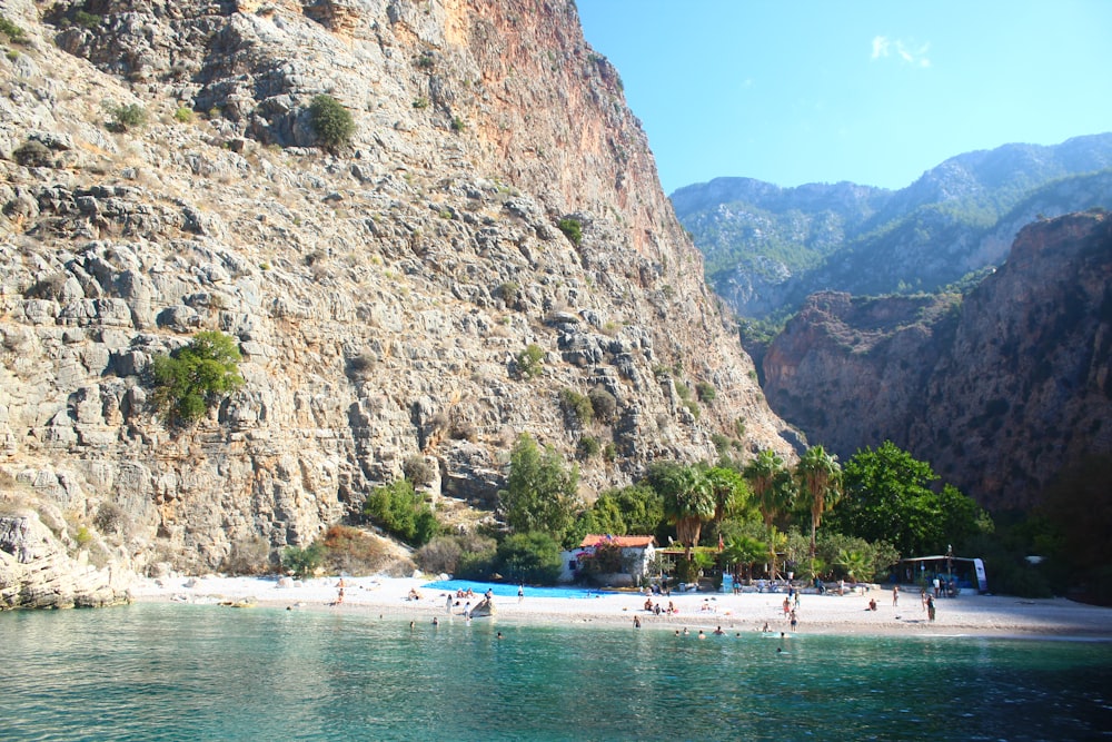 a beach with people and mountains