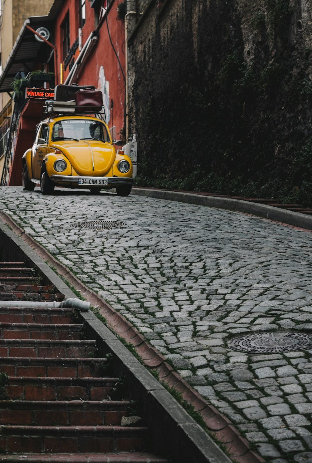 a yellow truck on a brick road