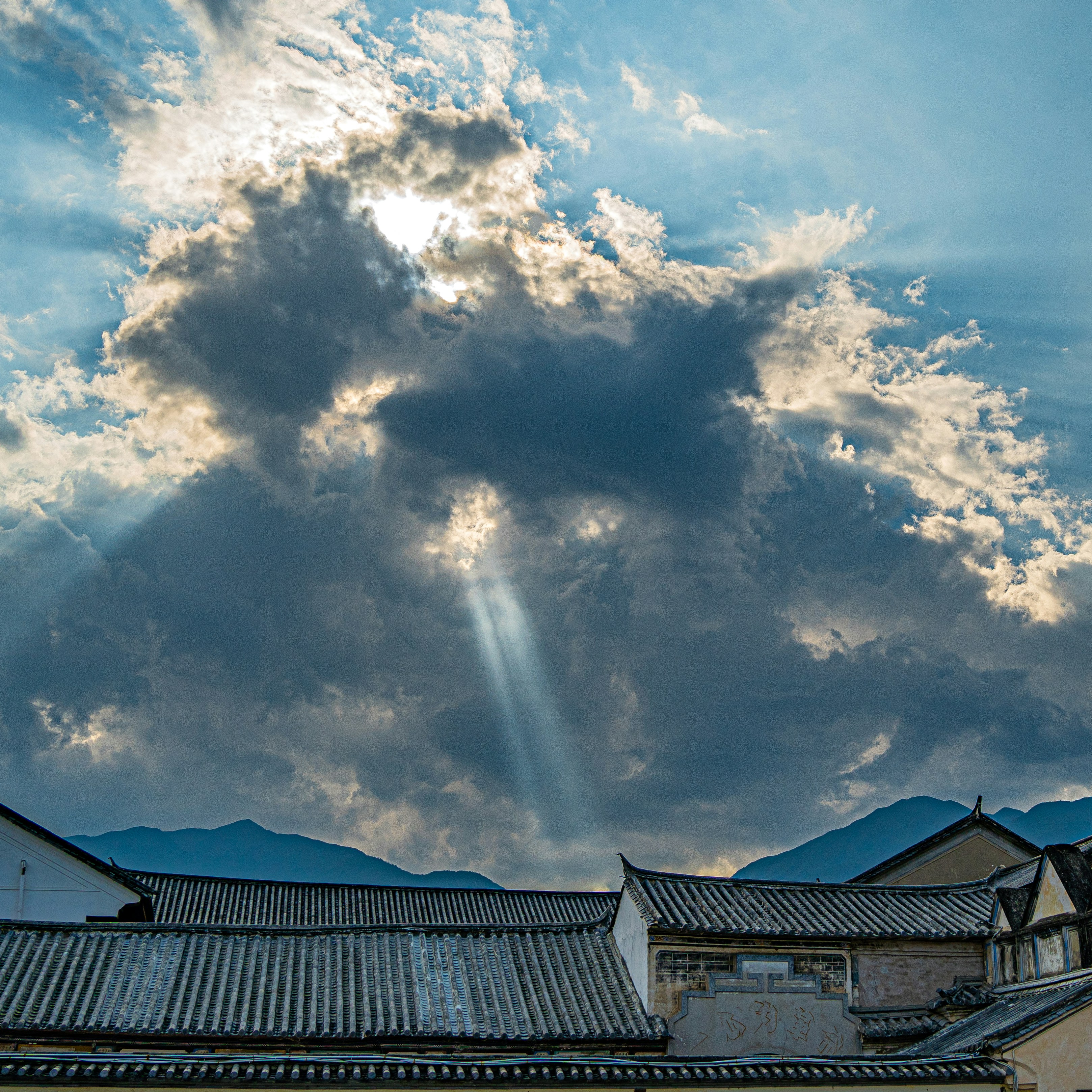 A group of rooftops with clouds above them photo – Free China Image on ...