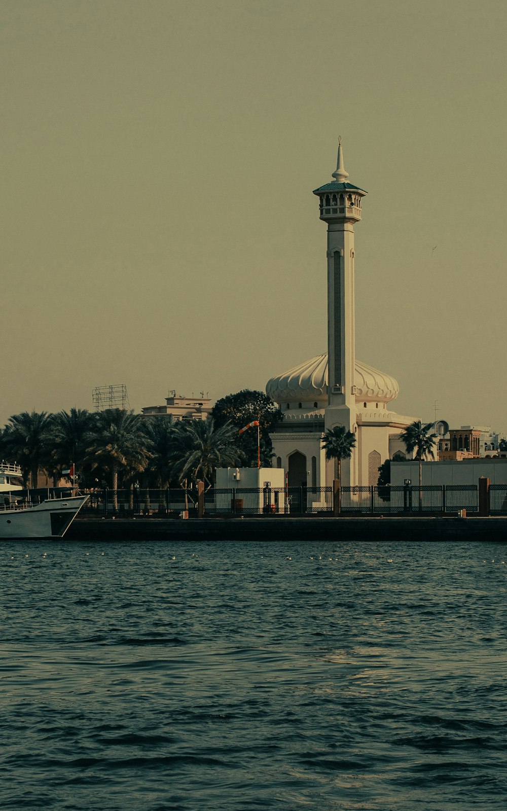 a building with a tower by the water