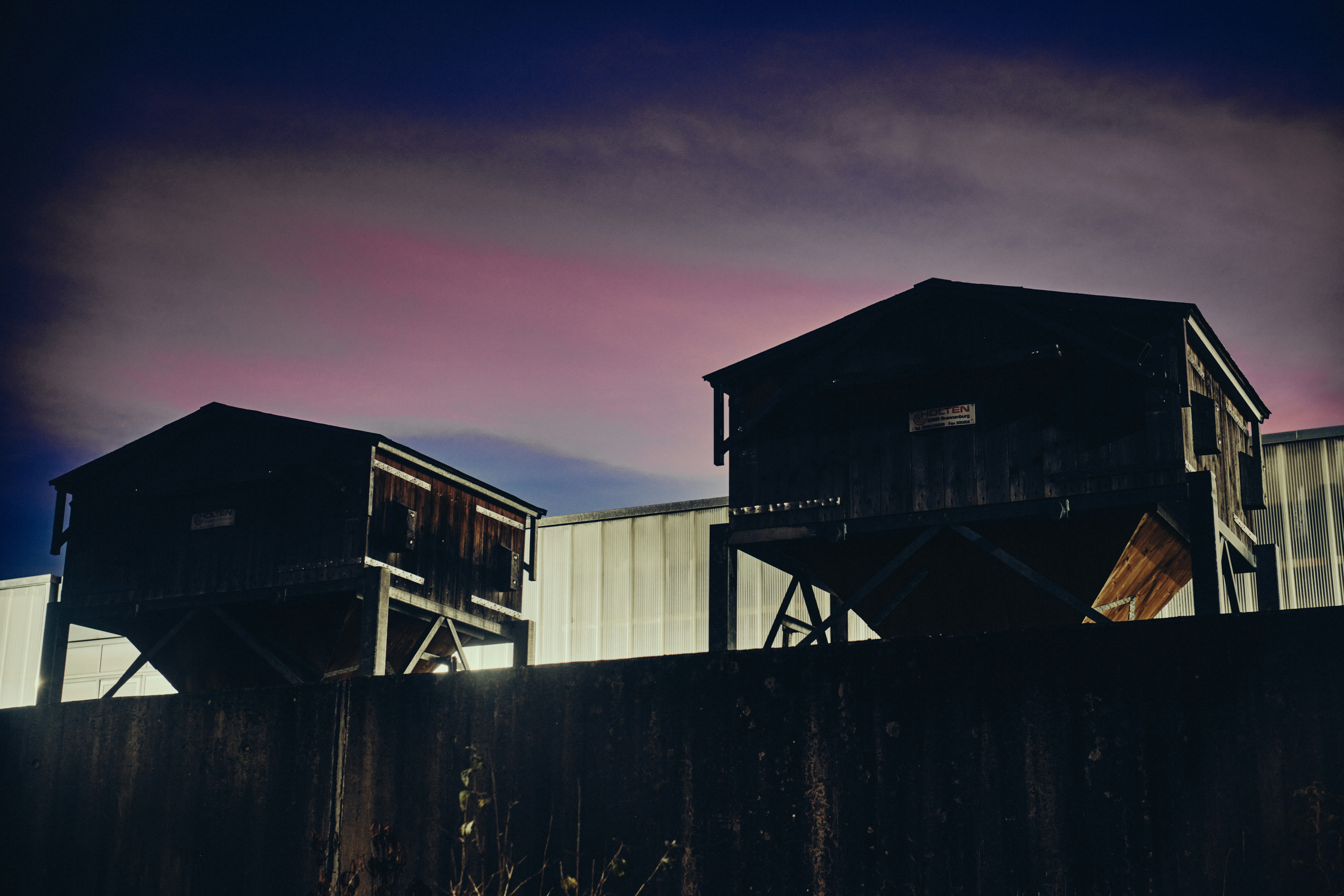 a group of buildings with a sunset in the background