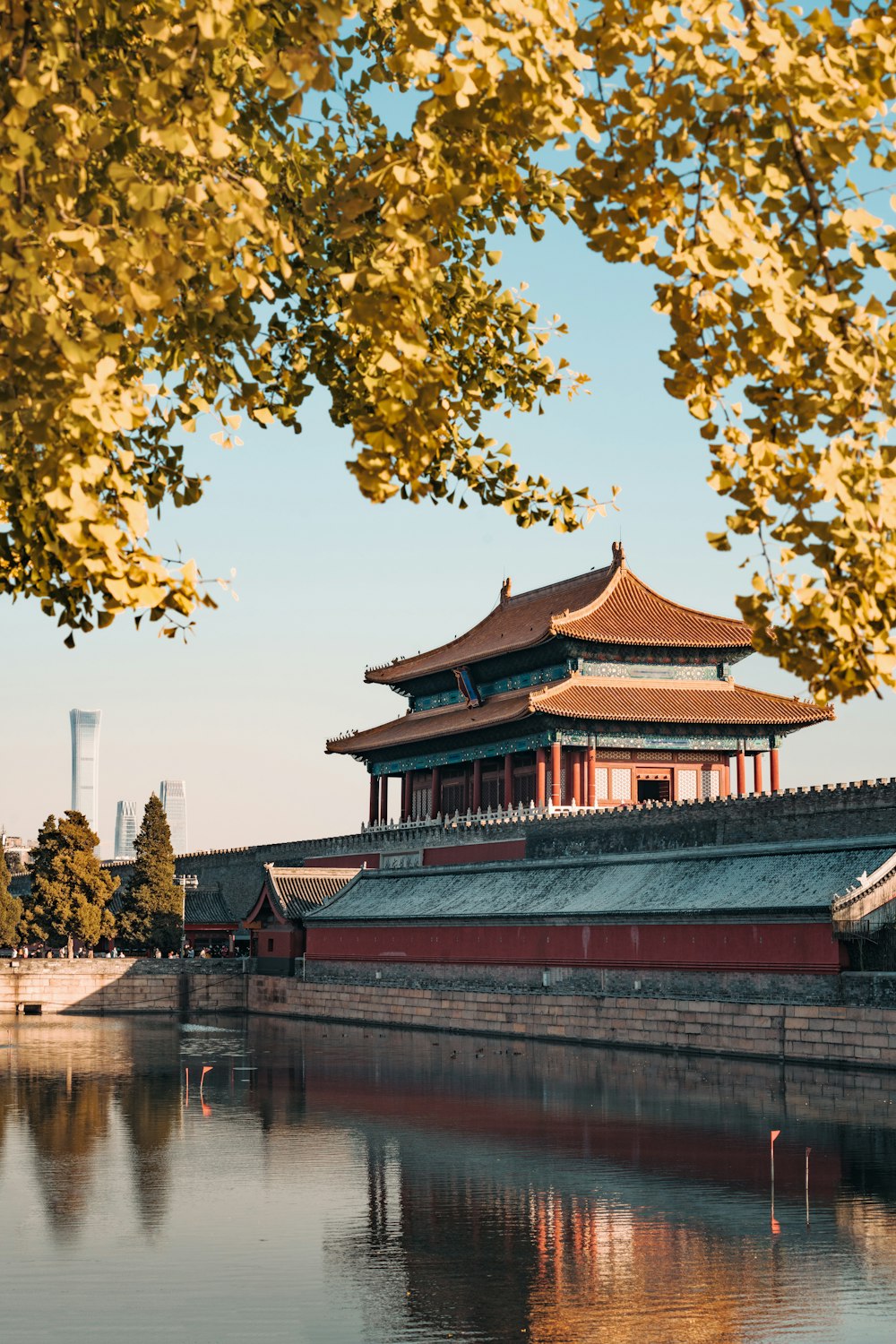 a building with a red roof by water