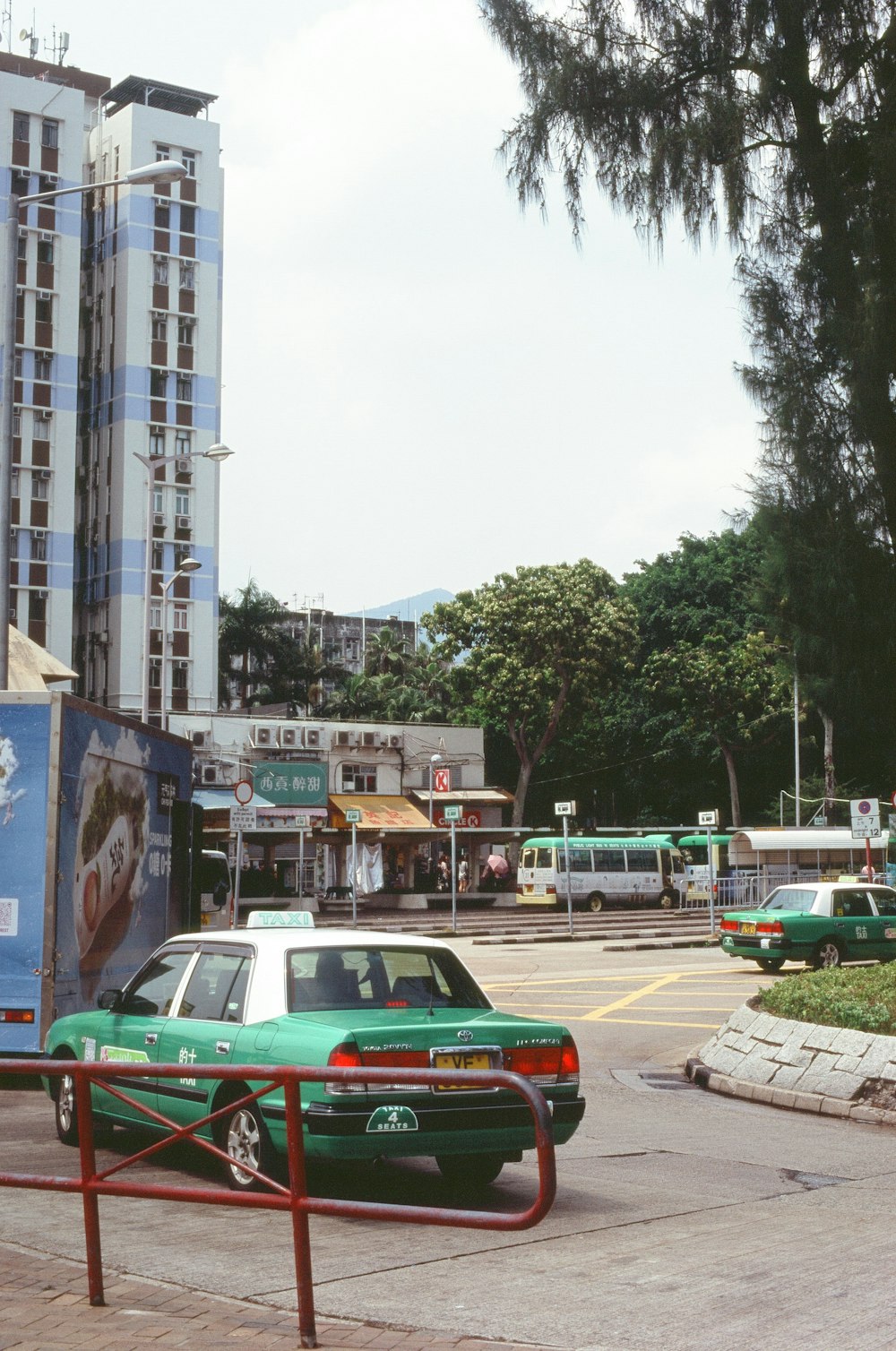 a green car parked on the side of a road