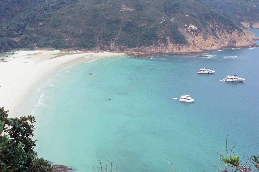 a beach with boats and a body of water