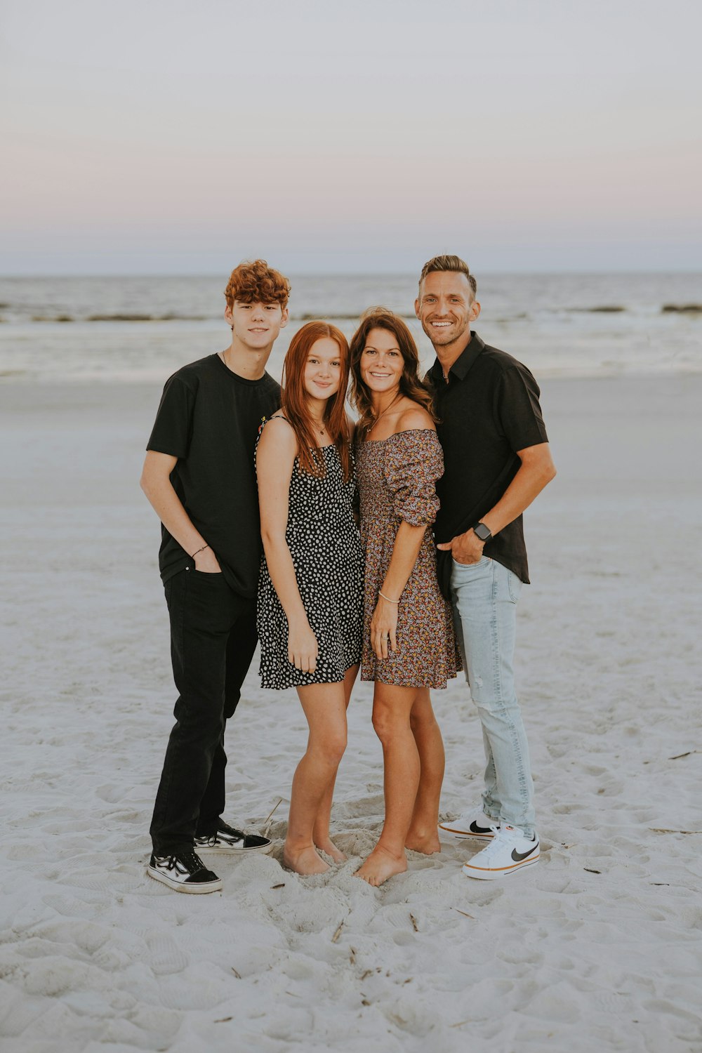 a group of people posing for a photo on a beach