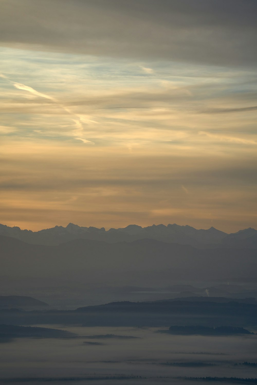 a body of water with mountains in the background