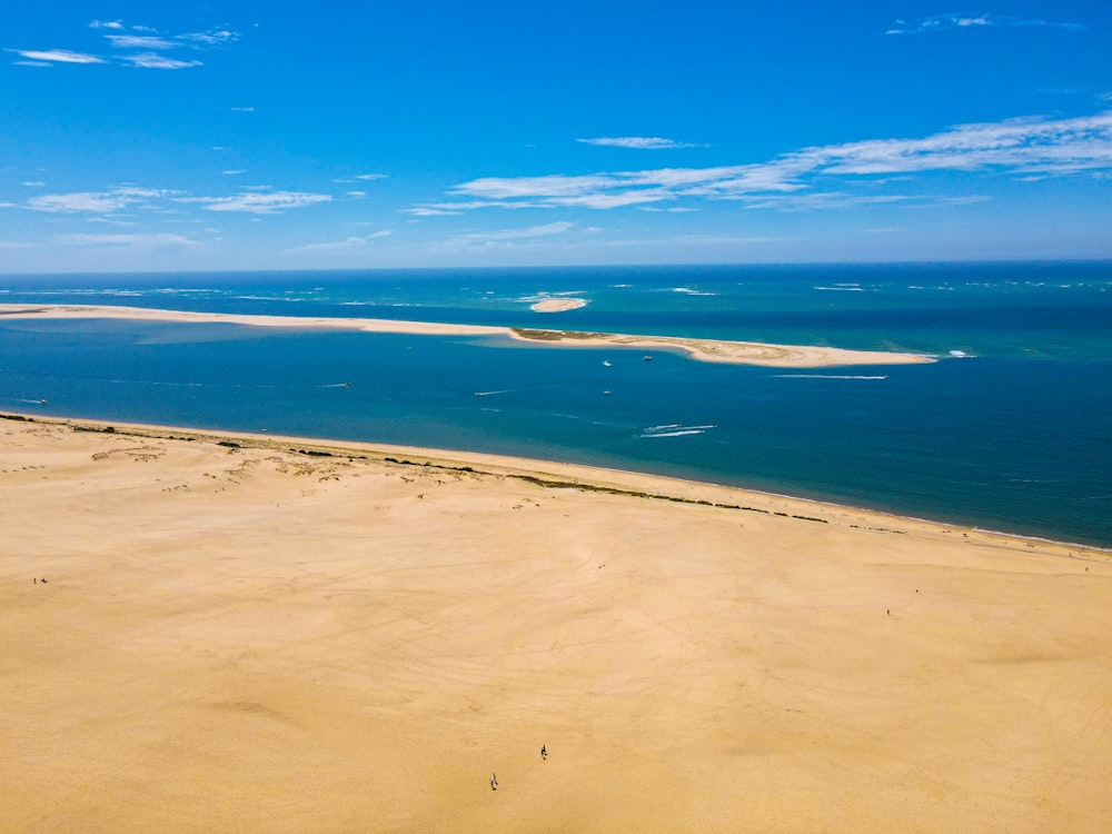 a sandy beach with blue water