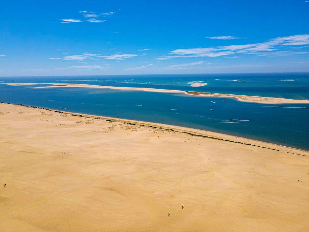 a sandy beach with blue water