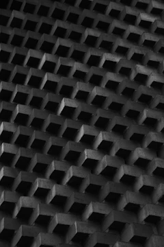 Artistic pattern of interlocking concrete blocks in natural light.