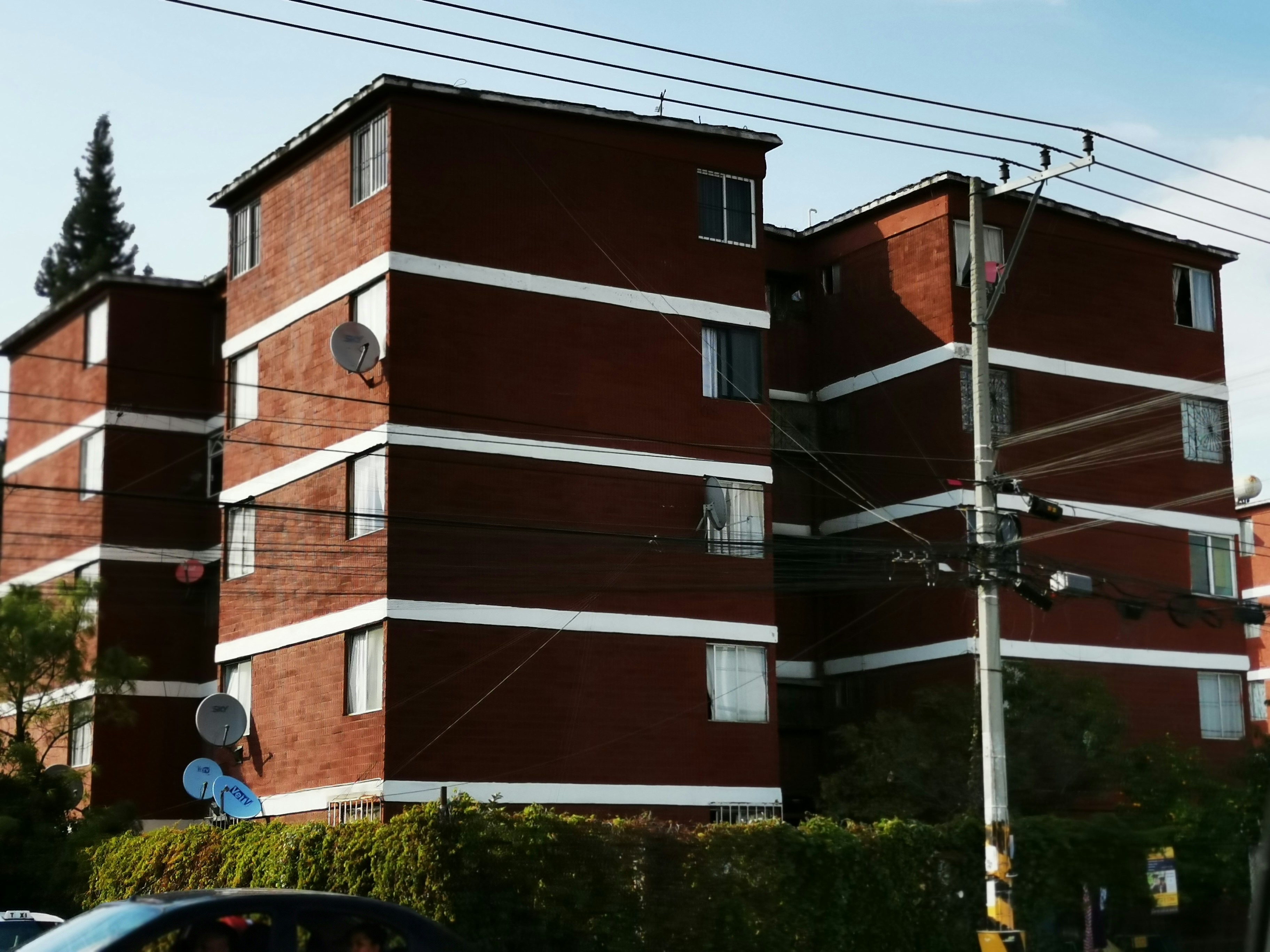 a brick building with a white stripe