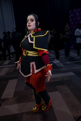 Close-up of a cosplayer in detailed costume posing at the convention.