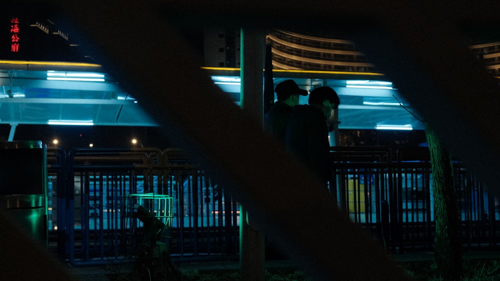 a group of people standing outside a building at night