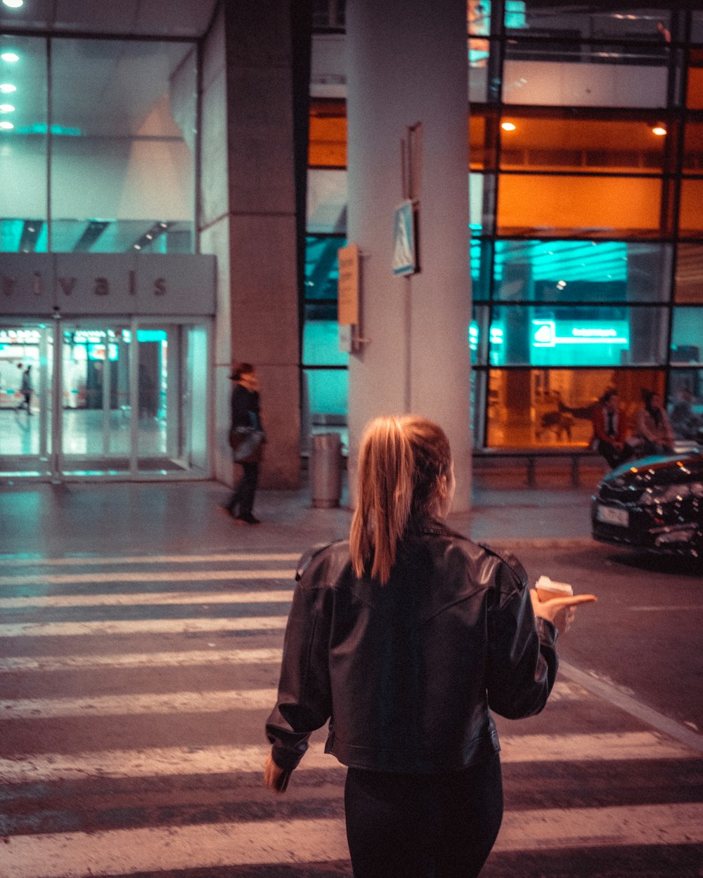 a woman walking across a street