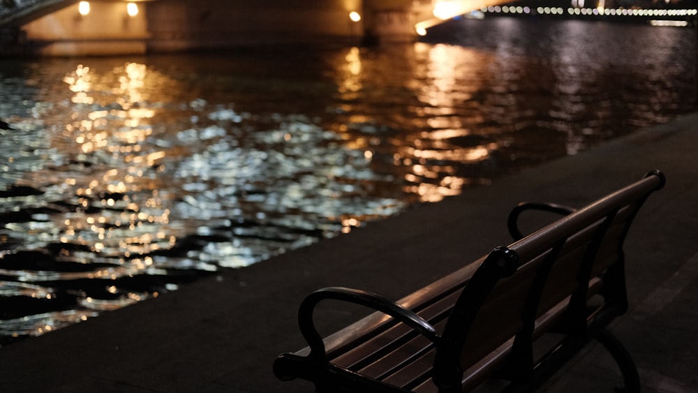 a bench sits in front of a body of water