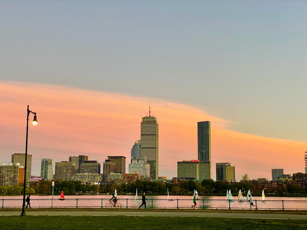 a city skyline with people walking and biking