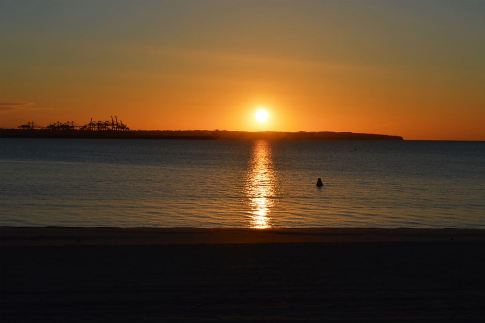 a sunset over a body of water