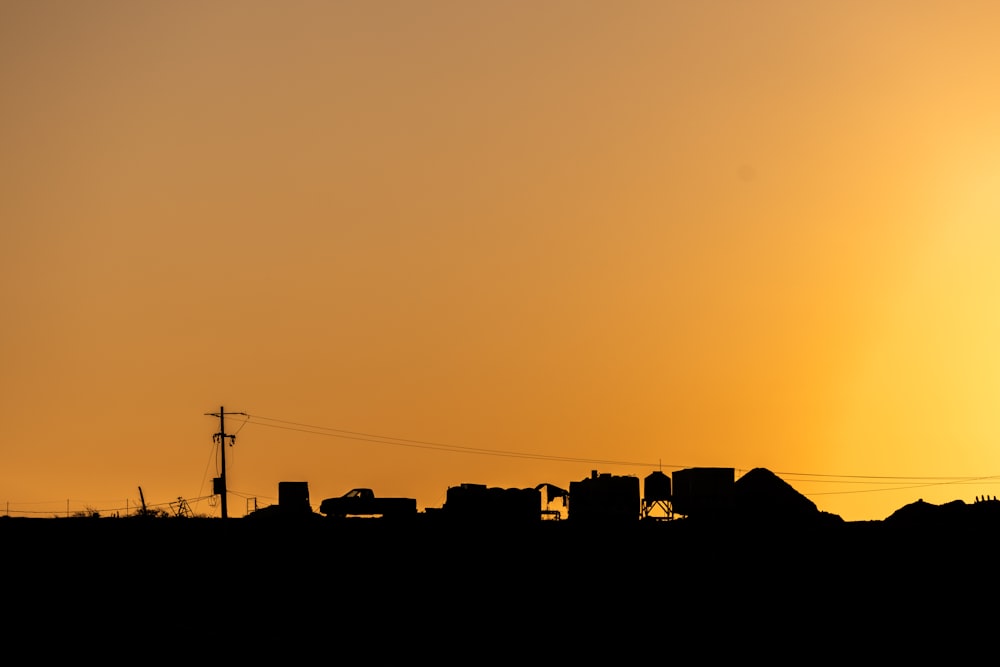 a silhouette of a city at sunset