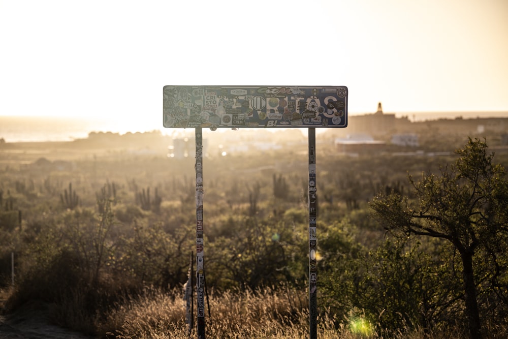 a sign in front of a field