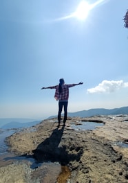 a person standing on a rocky beach
