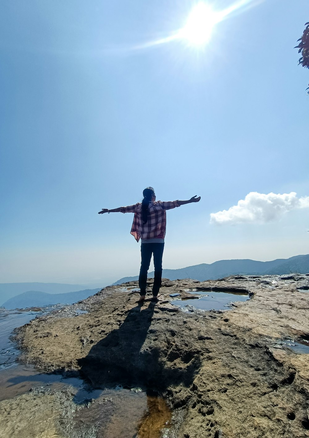 a person standing on a rocky beach