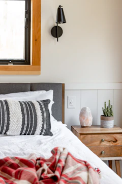 Cozy bedroom corner with Licht black and gold switch panels.