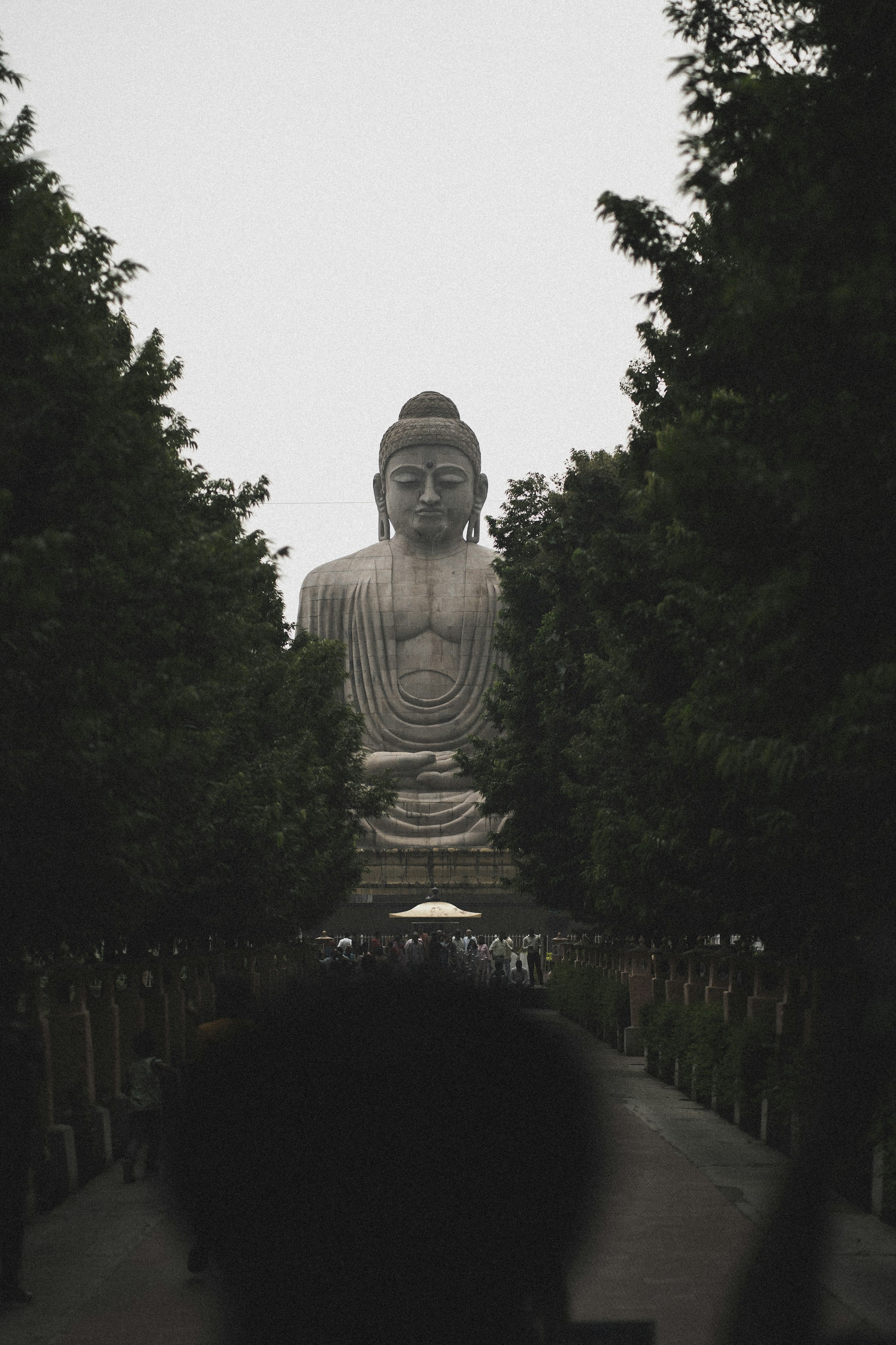 a large statue of a person with a crown and a long neck