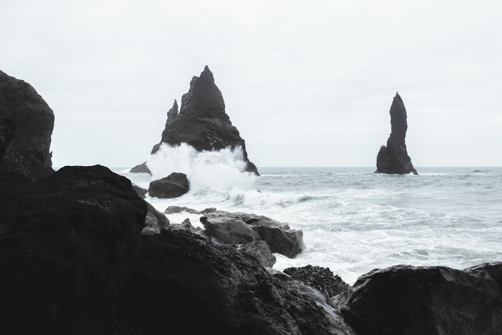 a rocky beach with waves crashing against the shore