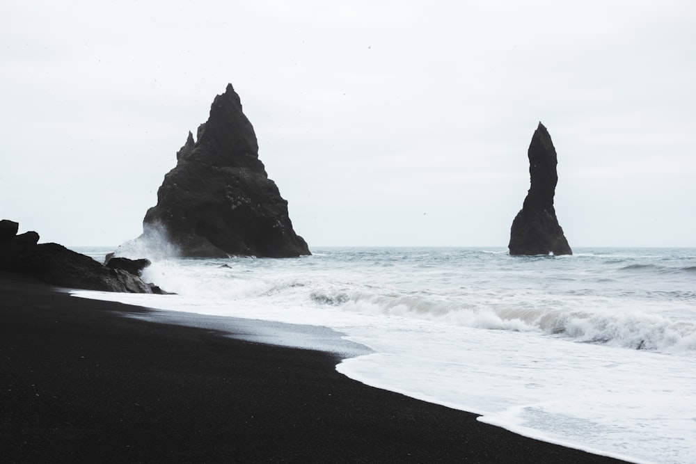 a beach with rocks and waves