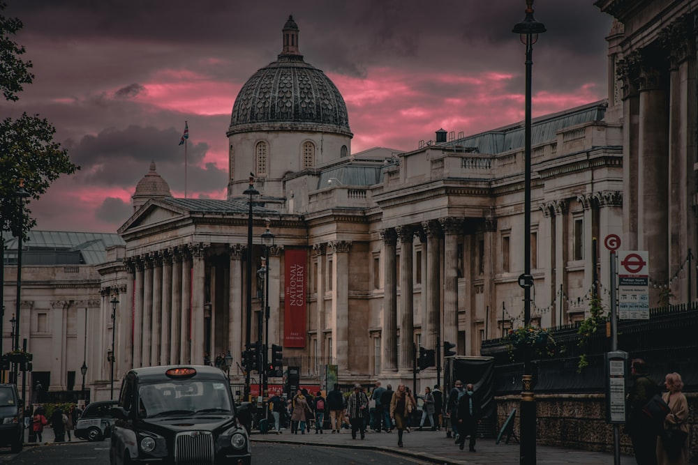 a busy street with a domed building with The National Gallery in the background