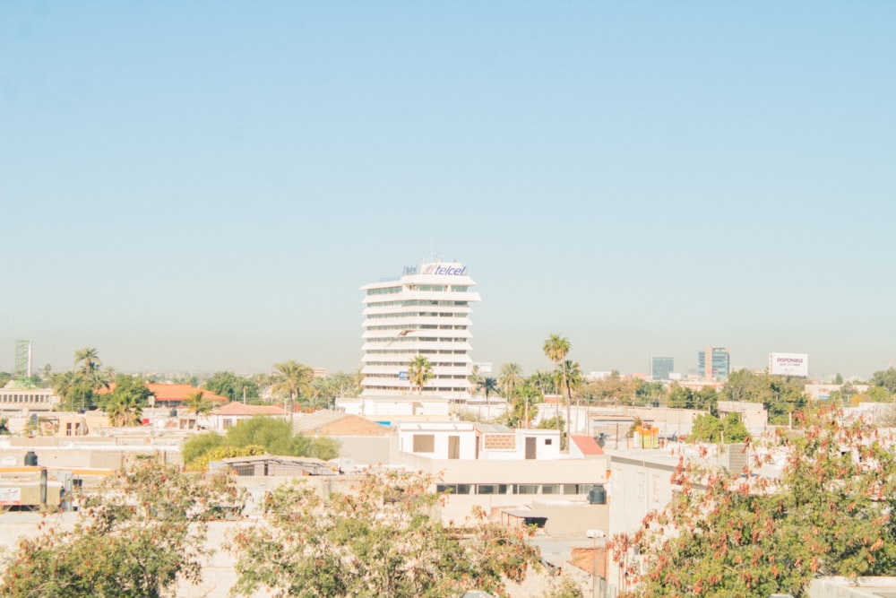 a large white building with a large white tower in the middle of a city