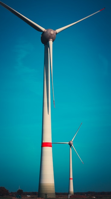 Modern wind turbines spinning gracefully against a bright blue sky