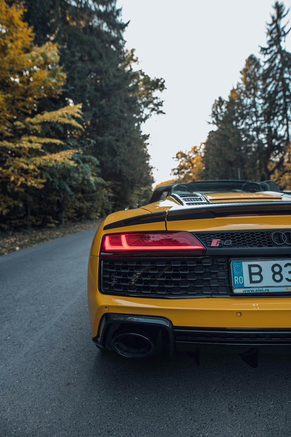 the back of a yellow sports car