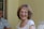 A senior woman happily reviewing documents with a Medicare advisor.