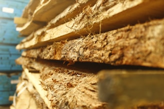 A close-up of wooden planks stacked neatly in a warehouse.
