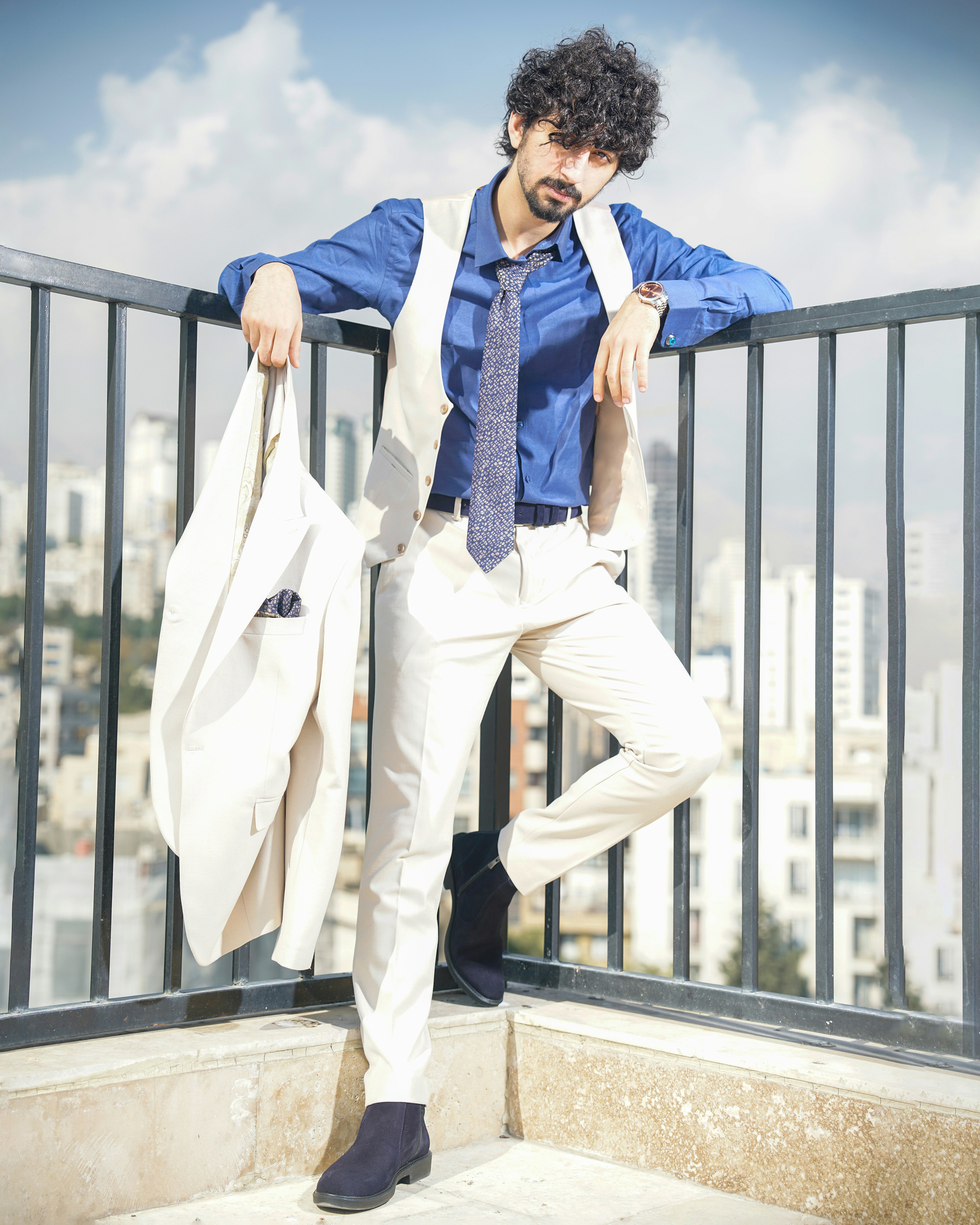 a man in a suit jumping on a balcony
