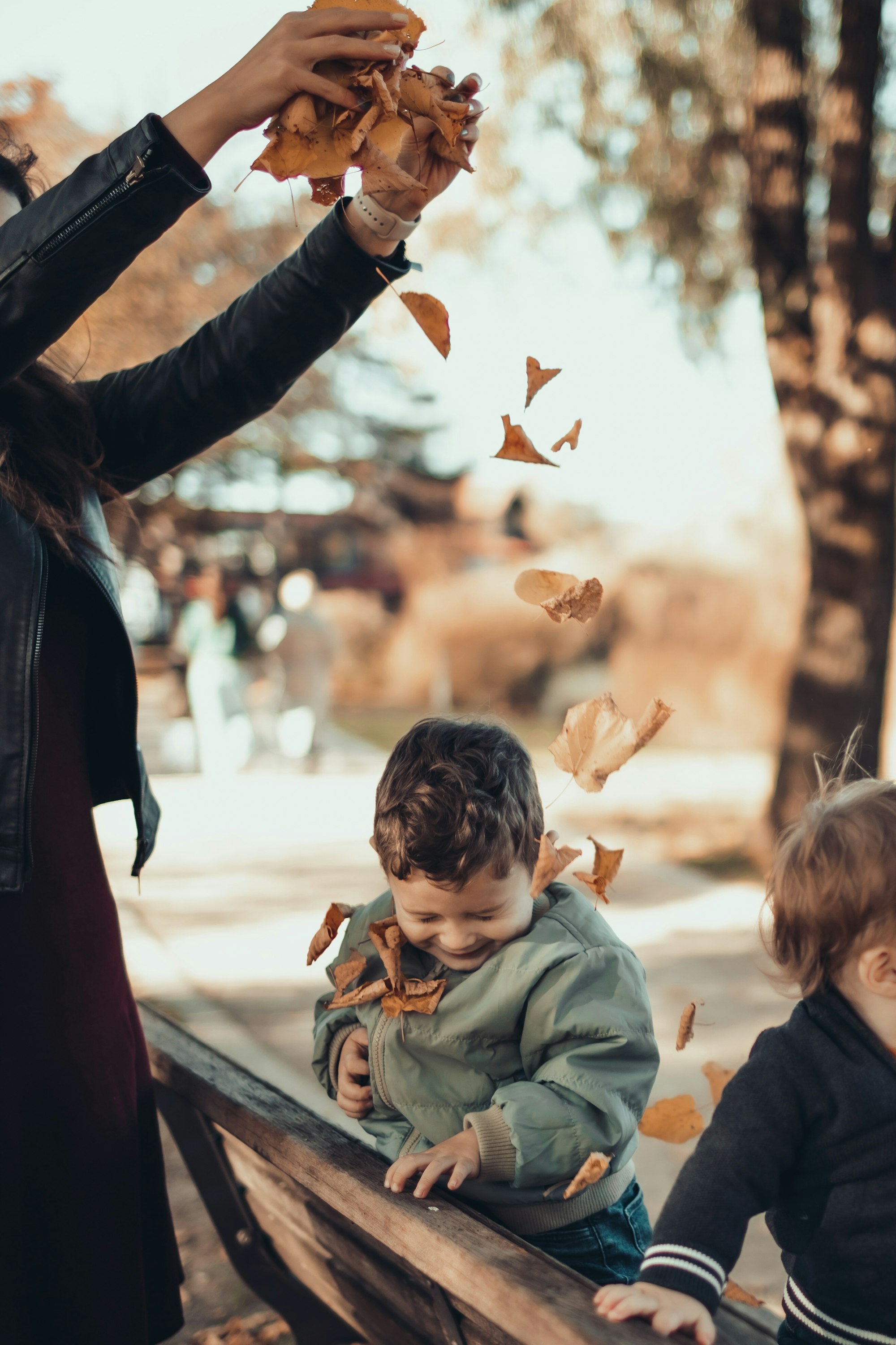 a person holding a hand up to a child's face