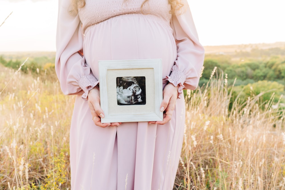 a person holding a picture of a field