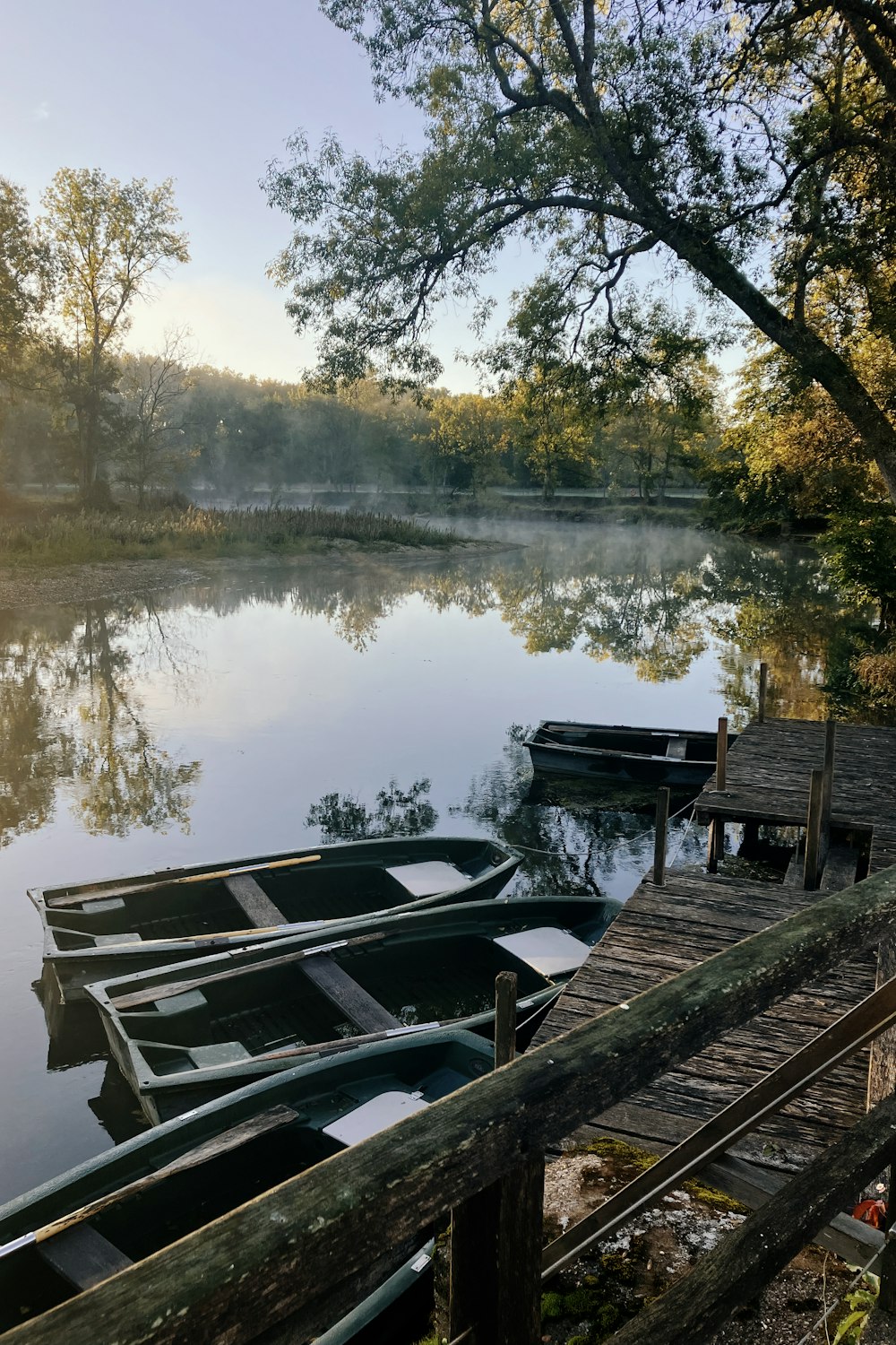 a group of boats sit on a dock