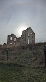 a stone castle in a field