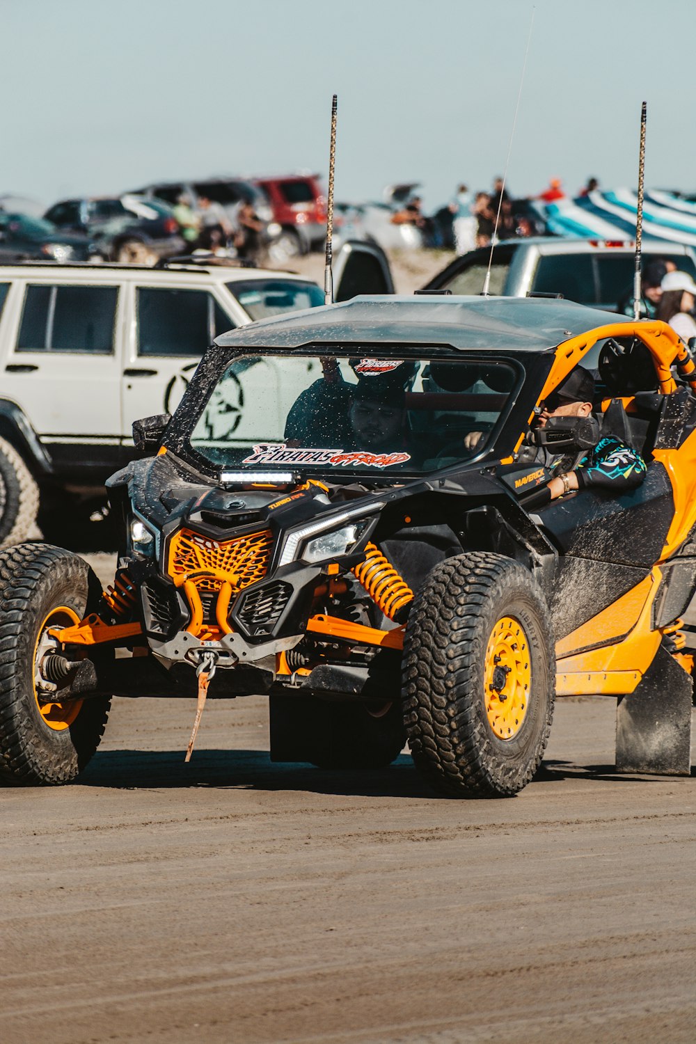 a monster truck with a crowd of people in the background