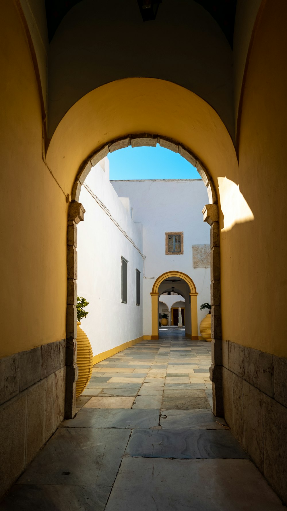 a hallway with a door and windows