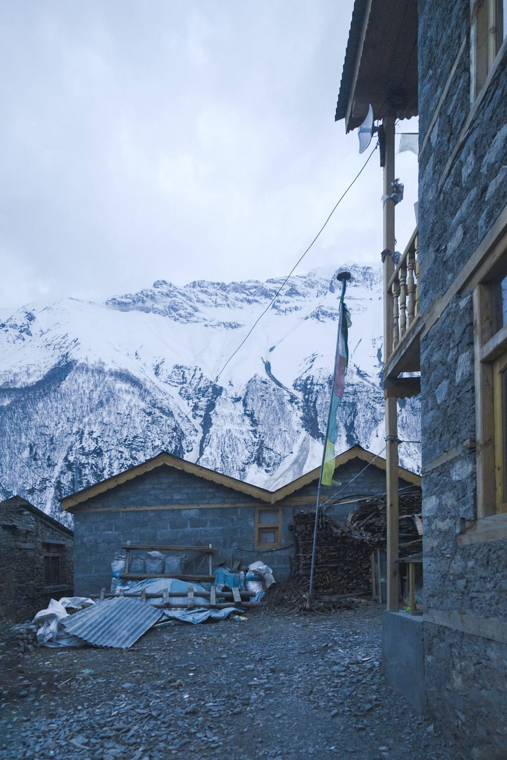 a building with a flag in front of a snowy mountain