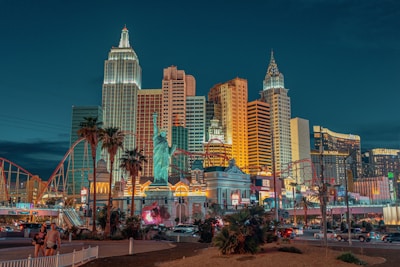 New York-New York Hotel and Casino with a statue and a body of water