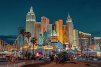 New York-New York Hotel and Casino with a statue and a body of water