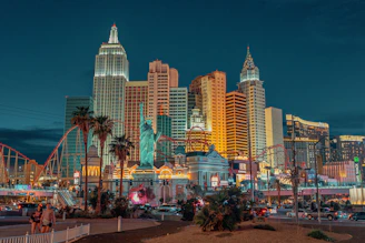 New York-New York Hotel and Casino with a statue and a body of water