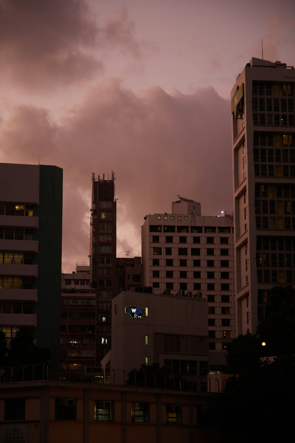 a group of buildings with a cloudy sky