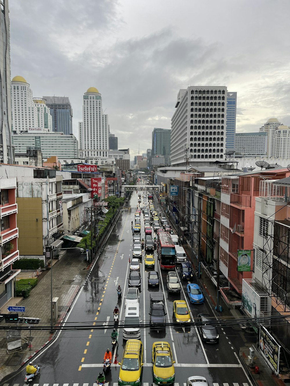 a busy street with cars and buildings