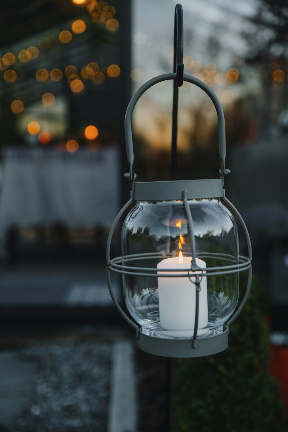 a glass lantern with a candle inside