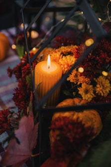 a candle surrounded by flowers