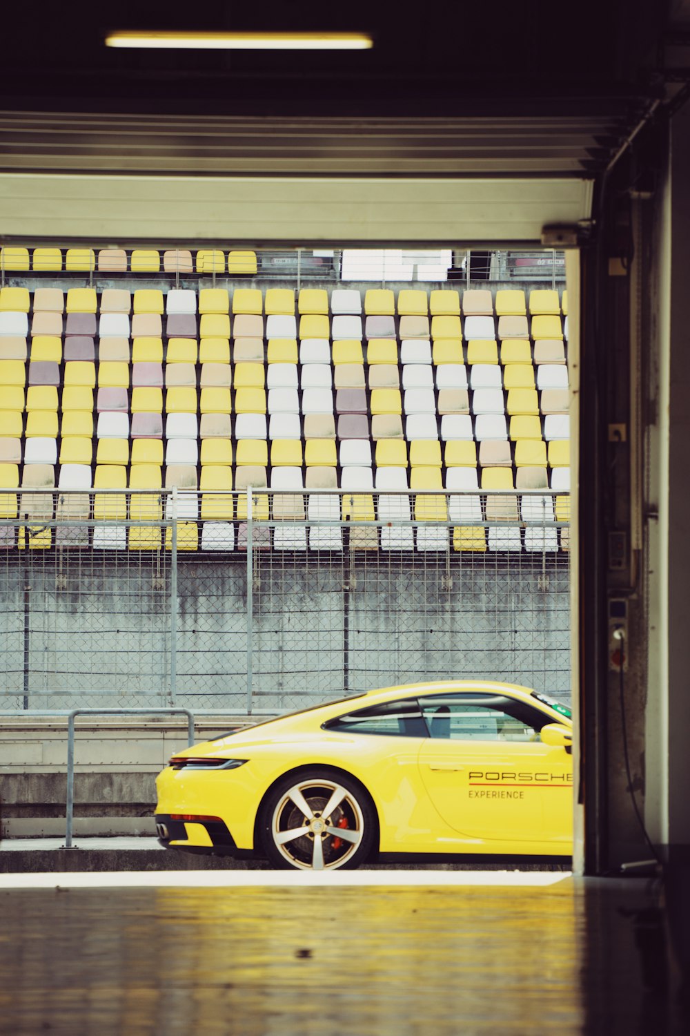 a yellow sports car parked in a parking garage